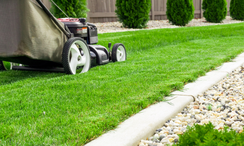 Mower mowing lawn
